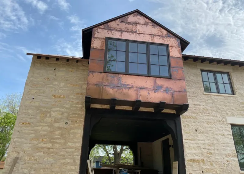 Copper metal panel facade on a stone building for Roof Repair in Chisago City