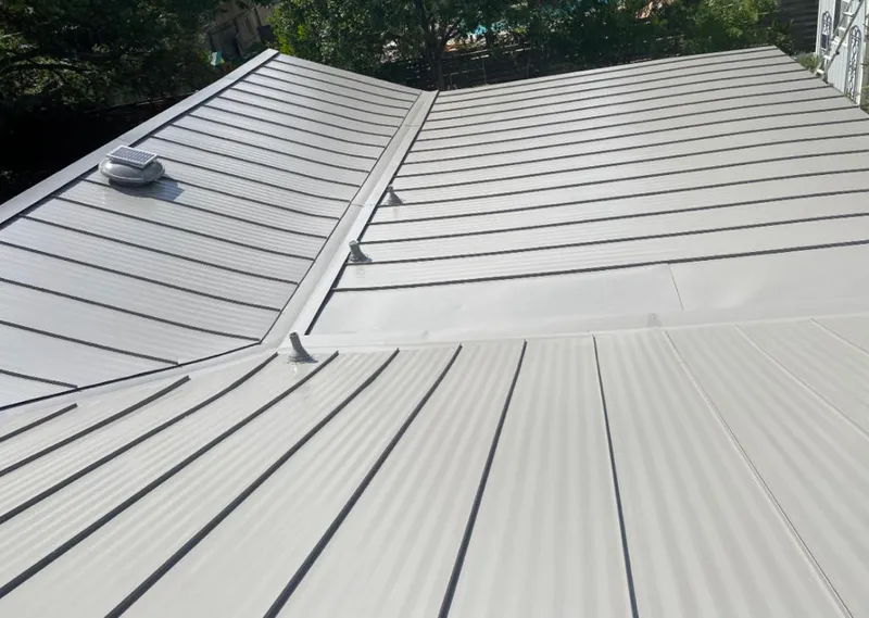 Solar attic fan installed on a metal roof for Roof Ventilation in Chisago City